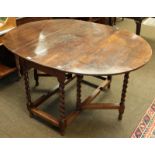 An early 20th century oak barley twist gate-leg dining table, 141cm by 108cm (open) by 73cm