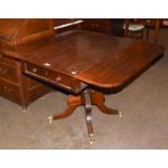 Regency mahogany centre-pedestal Pembroke table with single drawer and brass lion claw castors 107cm