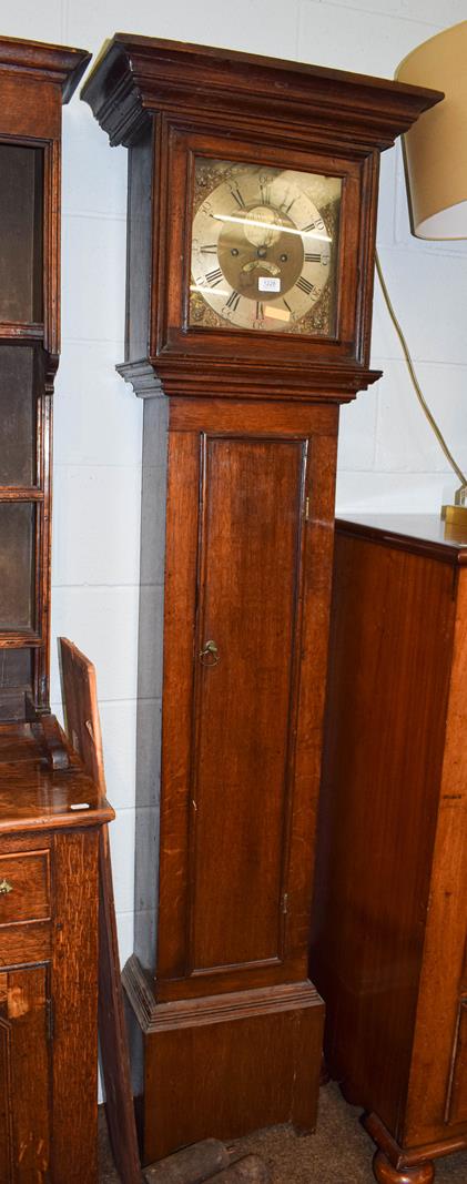 An oak eight day long case clock with 11'' square brass dial with a silvered plaque bearing a