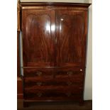 A 19th century mahogany linen press, raised over a three-height chest base on bracket feet,