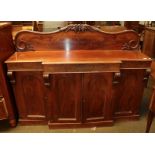 A Victorian mahogany breakfront sideboard with scrolling splashback and carved corbels, 159cm by