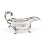A George II Silver Sauceboat, by John Barbe, London, 1745, oval and on three scroll capped pad feet,