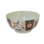 A Worcester slop bowl painted in polychrome enamels, with panels of Japanese flowers interspersed