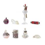 A cranberry glass scent bottle, a silver floral decorated scent bottle, five other scent bottles,