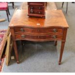 An early 20th century mahogany serpentine canteen table, quarter veneered, crossbanded and raised on