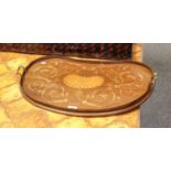 An Edwardian marquetry serving tray of paterra design with a border of arabesques, kidney form