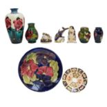 A collection of Moorcroft pottery including a Hibiscus pattern vase and ginger jar, two Clematis