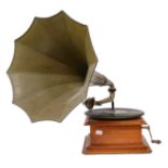 An oak wind-up gramophone with black and gilt japanned arm and metal horn