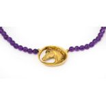 A 9 carat gold amethyst and sapphire necklace, by Harriet Glen, the yellow textured horse head