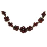 A Victorian garnet necklace, formed of alternating square-shaped and kite-shaped rose cut garnet