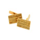 A pair of 18 carat gold cufflinks, the yellow rectangular plaques decorated with four rows of rope