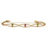 A peridot and pink tourmaline bracelet, the oval cut pink tourmaline flanked by oval cut peridots in