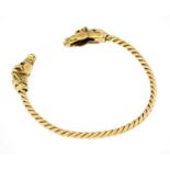 A 9 carat gold torque bangle, by Harriet Glen, the yellow rope twist bangle terminates to horse head