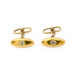 A pair of diamond cufflinks, the yellow plain polished torpedo-shaped plaque inset with an old cut