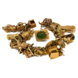 A 9 carat gold fancy link bracelet, hung with various charms including a cuckoo clock, a violin, a