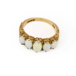 A 9 carat gold opal five stone ring, the graduated oval cabochon opals in yellow claw settings, to