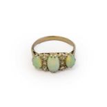 An opal and diamond ring, three graduated oval cabochon opals spaced by trios of old cut and eight-