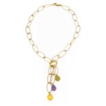 An amethyst and citrine fancy link necklace, the yellow oval trace links centred by a disc which