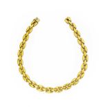 A fancy link necklace, formed of three rows of yellow plain polished torpedo shaped links, length