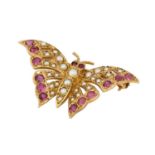 A 9 carat gold ruby and split pearl butterfly brooch, set throughout with split pearls and round cut