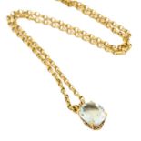 An 18 carat gold aquamarine pendant on chain, the oval cut aquamarine in a yellow claw setting