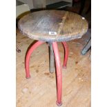 Industrial machinist's swivel stool with red painted metal tripod legs