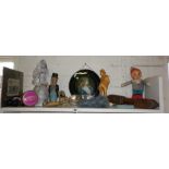 Shelf of assorted items including humorous painted carved figure etc.