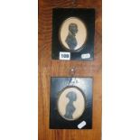 Two Victorian painted silhouettes of a man and a woman