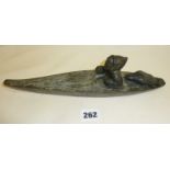 Carved stone inuit eskimo and seal on canoe, signed under