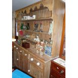 Large Victorian pine kitchen dresser having four shelves above four drawers with china knobs and two