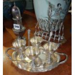 Silver-plated toast rack, egg cups on tray and a sugar sifter