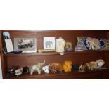 Two shelves of assorted elephant related ornaments and figures