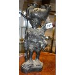 Tribal Art - African carved hardwood figure of a hunter carrying an elephant on his head, signed