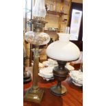 Tall Victorian brass column oil lamp with cut clear glass reservoir and another lamp