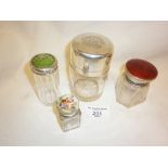 Three silver and enamel topped perfume bottles and a silver topped glass jar
