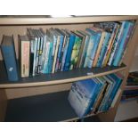 Two shelves of books on aviation