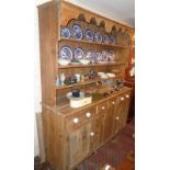 Large Victorian pine kitchen dresser having four shelves above four drawers with china knobs and 2