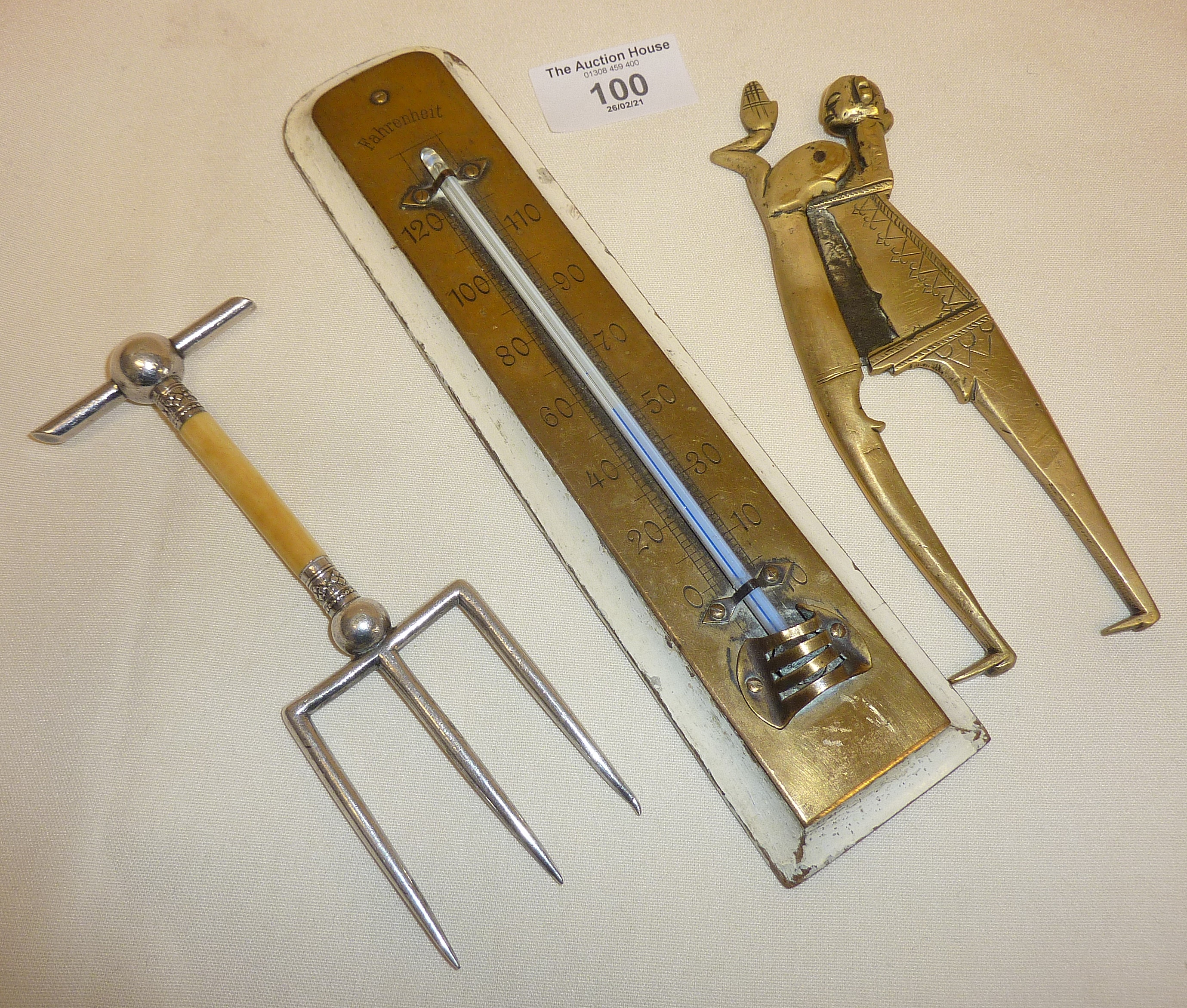 Figural brass betel nut cutters, silver-plated bread fork and an old brass thermometer