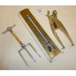 Figural brass betel nut cutters, silver-plated bread fork and an old brass thermometer