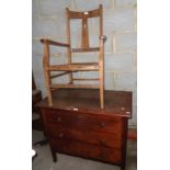 Chest of three drawers and a rush seat elbow chair