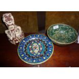 Two Iznik pottery pieces and a slipware figurative bottle