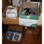 Two boxes of vinyl singles and another of cassette tapes
