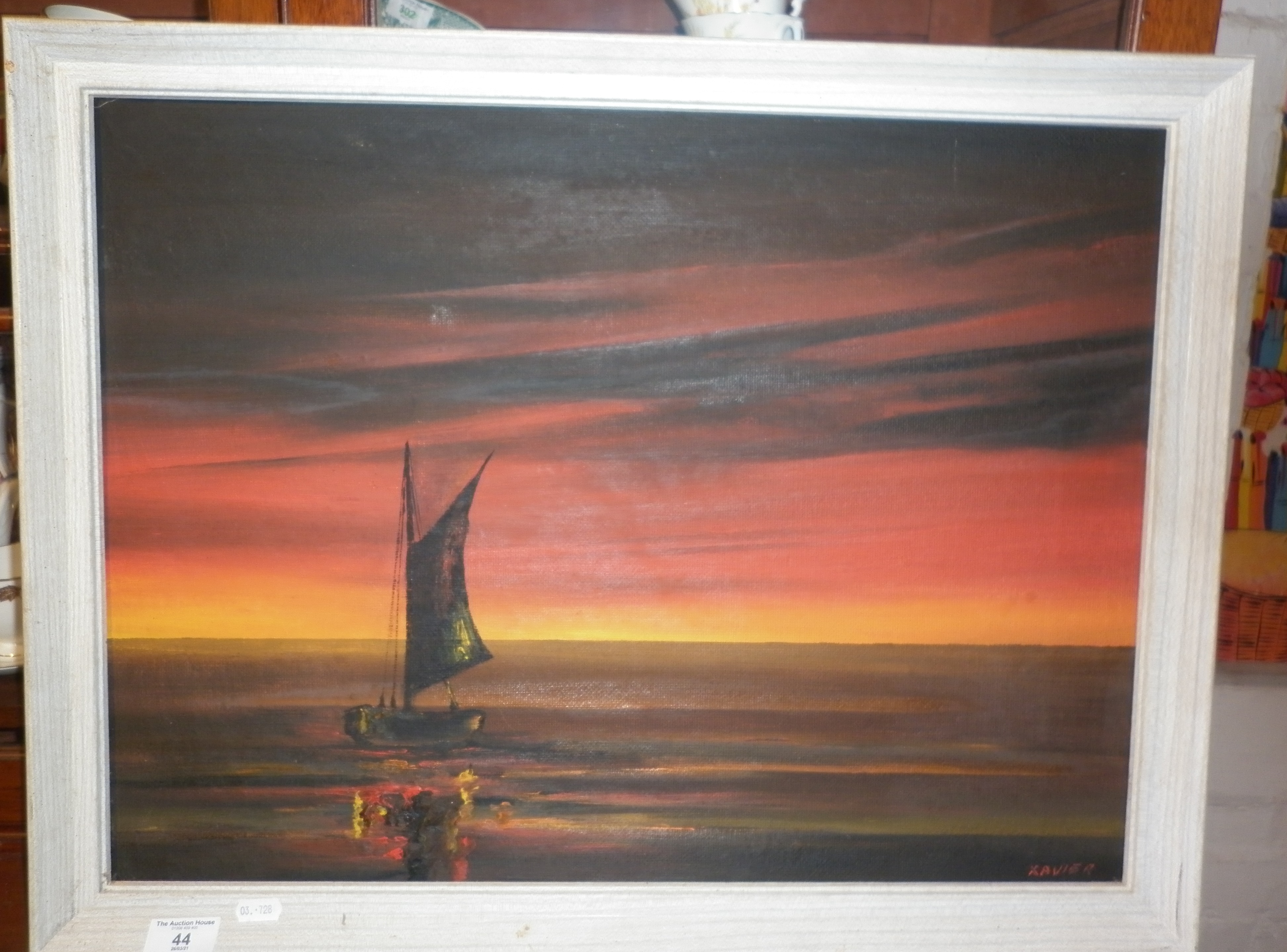 Oil on board of a sailboat at sunset, signed 'Xavier'