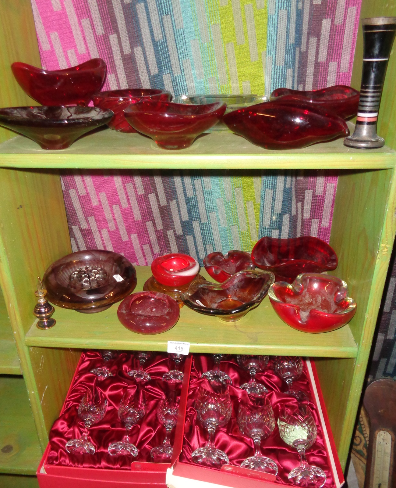 Three shelves of assorted glassware, inc. red glass Whitefriars ashtray and bowls