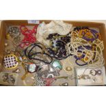 Tray of vintage costume jewellery, badges, Native American turquoise bear pendant, etc.