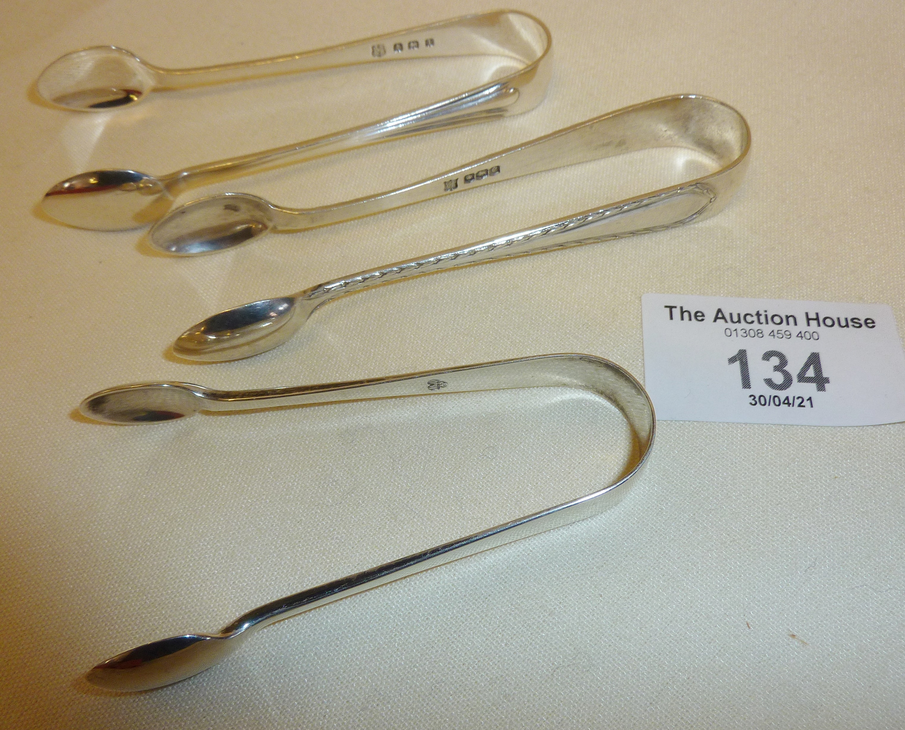 Three pairs of hallmarked silver sugar tongs - approx. 34g