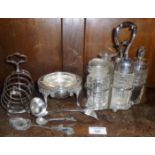 Six bottle silver-plated cruet, toast rack and a butter dish