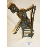 Bronze sculpture of girl playing with cat, signed under chair