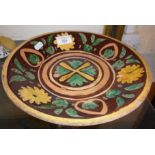 Terracotta dish decorated with flowers and leaves