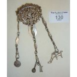 Sterling silver Chatelaine decorated with cherubs surrounding a heart, some charms attached.